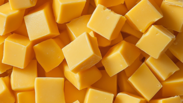 many blocks of creamy yellow cheddar cheese